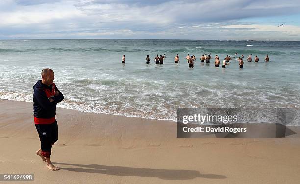 Eddie Jones, the England head coach walks down the beach as his players take a swm in the ocean during the England recovery session held at Coogee...