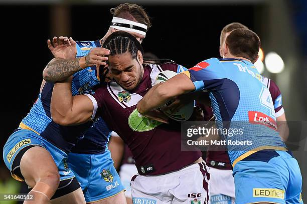 Martin Taupau of the Sea Eagles is tackled during the round 15 NRL match between the Gold Coast Titans and the Manly Sea Eagles at Cbus Super Stadium...