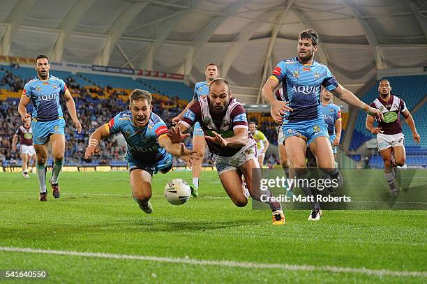 William Zillman of the Titans competes for the ball against Brett Stewart of the Sea Eagles during the round 15 NRL match between the Gold Coast...