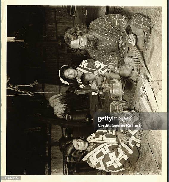 INTERIOR OF AN AINU HOME SHOWING OWNER AND FAMILY. YEZO, JAPAN. UNDATED PHOTOGRAPH.