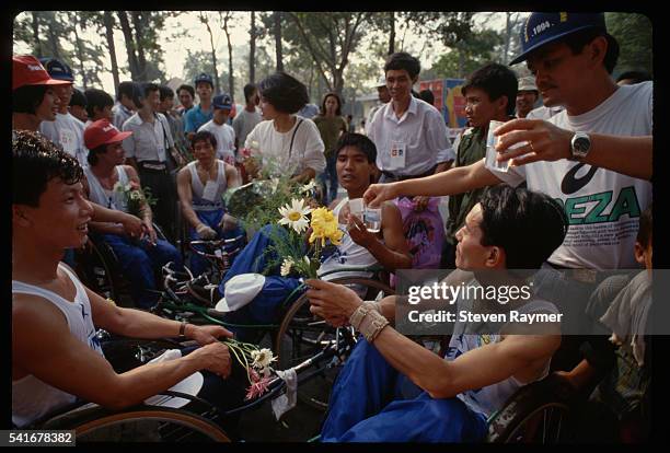 Wheelchair athletes celebrate after crossing the finish line at the Ho Chi Minh International Marathon in Ho Chi Minh City, Vietnam.