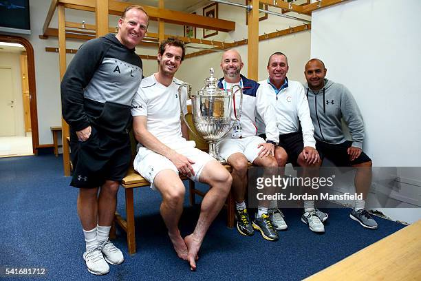 Andy Murray of Great Britain poses with the Aegon Championships trophy with fitness coach Matt Little, Jamie Delgado, coach Ivan Lendl and physio...