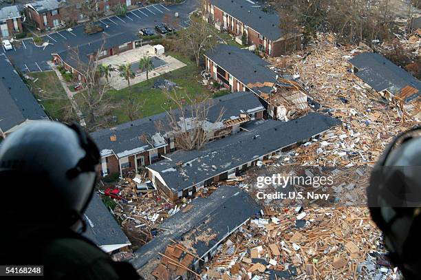 Navy air crewmen, assigned to Helicopter Support Unit Pensacola, survey the damage from hurricane Katrina en route to Stennis Space Center,...