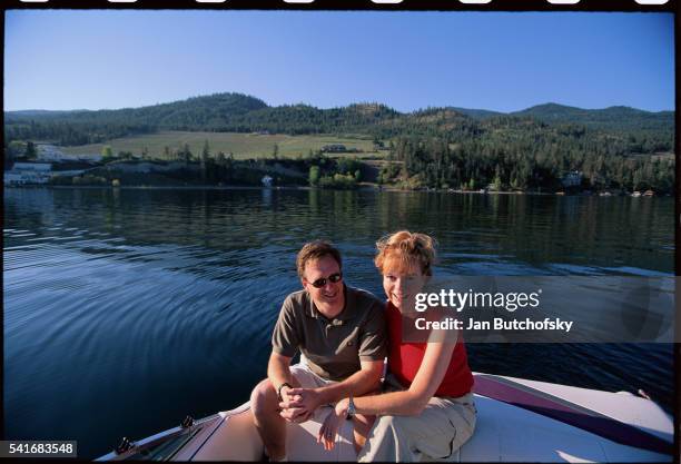 couple boating on lake okanagan - kelowna stock pictures, royalty-free photos & images