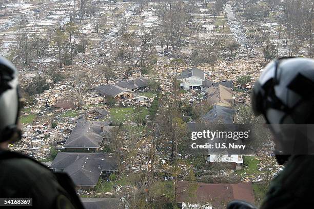 Navy air crewmen, assigned to Helicopter Support Unit Pensacola, survey the damage from hurricane Katrina en route to Stennis Space Center,...