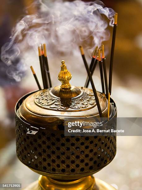 bars of incense on a former burner of bronze - pomander stock pictures, royalty-free photos & images
