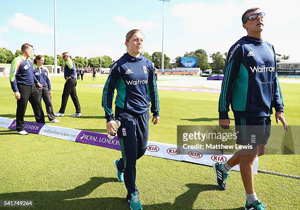 Heather Knight, captain of England and Mark Robinson, Head Coach of England walk off the pitch, after the match was abandoned during the 1st Royal...