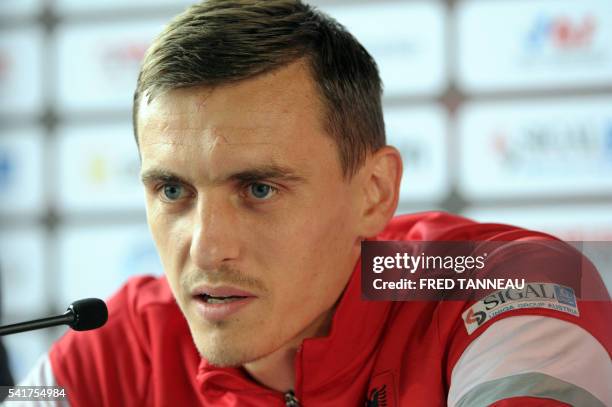 Albania's midfielder Burim Kukeli addresses a press conference at the team's training ground in Perros-Guirec, western France, on June 20 during the...