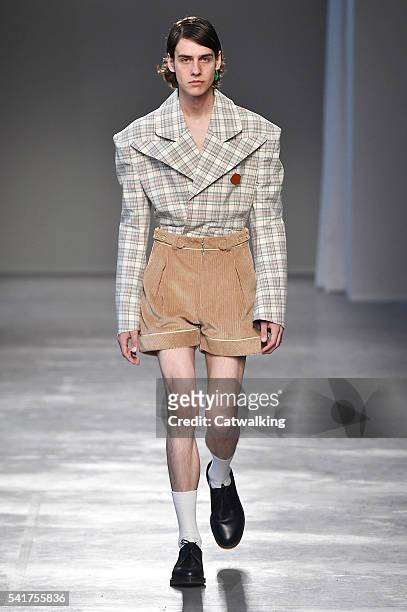 Model walks the runway at the Moto Guo Spring Summer 2017 fashion show during Milan Menswear Fashion Week on June 20, 2016 in Milan, Italy.