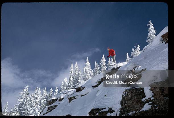 An expert skier jumps off a rock ledge. Vail, Colorado.