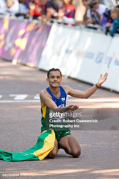 September 8, 2012 London, United Kingdom: Tito Sena of Brazil drops to his knees after crossing the finish line to win the men's T46 Marathon on the...