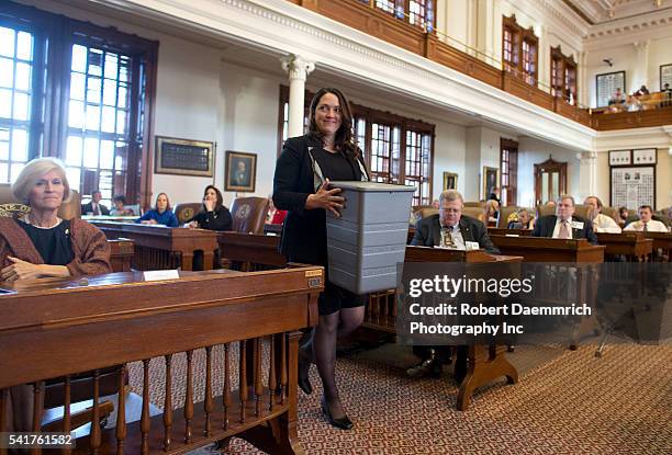 Secretary of State worker carries the ballot box as Texas Republican members of the Electoral College vote for the presidential ticket of Mitt...