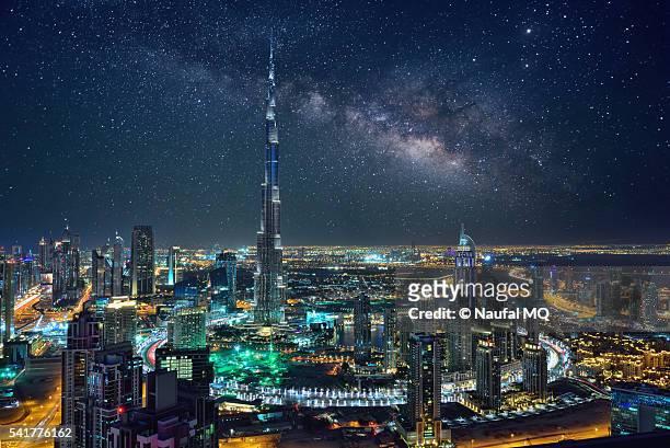 surreal milky way behing burj khalifa, dubai - united arab emirates night stock pictures, royalty-free photos & images