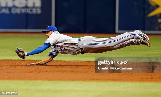 Chris Colabello of the Toronto Blue Jays makes a diving stop against the Tampa Bay Rays during the Opening Day game at Tropicana Field on Sunday,...