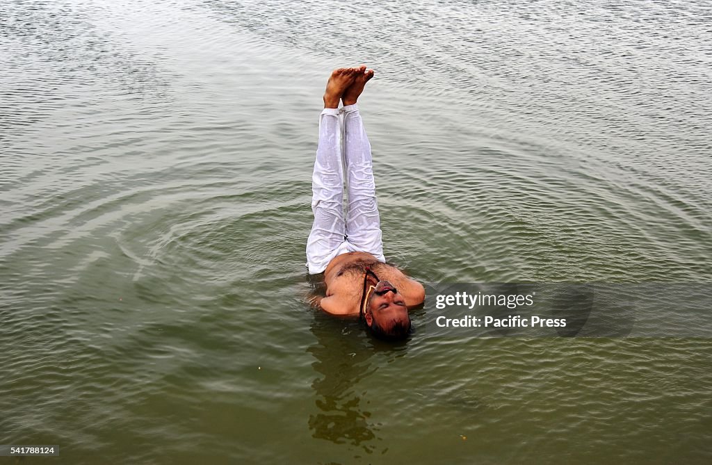An Indian man performing yoga in Water of River Yamuna on...