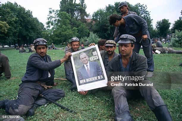 In the year following the Romanian revolution, anti-Communist protests are broken up by miners from the Jiu Valley called in by President Iliescu.