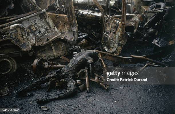 The charred corpse of an Iraqi soldier lies among the rubble after an Iraqi convoy is destroyed by coalition bombing during the Persian Gulf War. In...