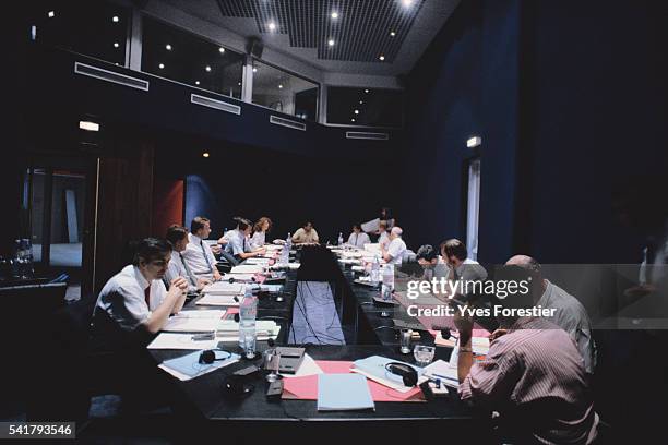 Policemen meet at Interpol Headquarters.