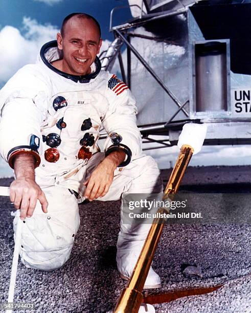 Alan Bean*-Astronaut, USAAlan Bean in space suit kneeling in front of a lunar module in the NASA training center