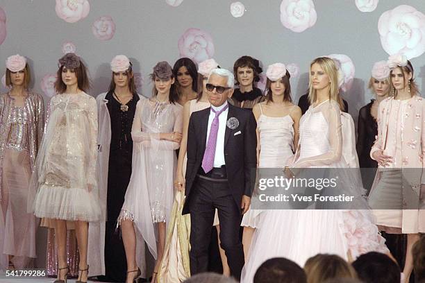 Designer Karl Lagerfeld appears on the runway with models wearing the latest bridal creations at the end of the Chanel 2002 Spring/Summer "Haute...