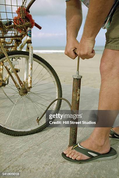 pumping air into bicycle tire - air pump stock pictures, royalty-free photos & images