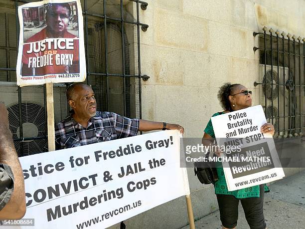 People protest outside a Baltimore, Maryland court house on June 20, 2016 at the trial of police officer Caesar Goodson for his role in events that...