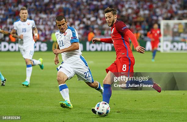 Adam Lallana of England and Viktor Pecovsky of Slovakia compete for the ball during the UEFA EURO 2016 Group B match between Slovakia and England at...
