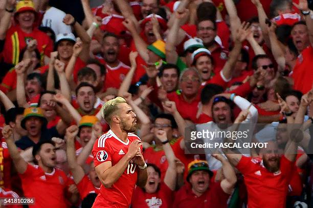 Wales' midfielder Aaron Ramsey celebrates the team's first goal during the Euro 2016 group B football match between Russia and Wales at the Stadium...