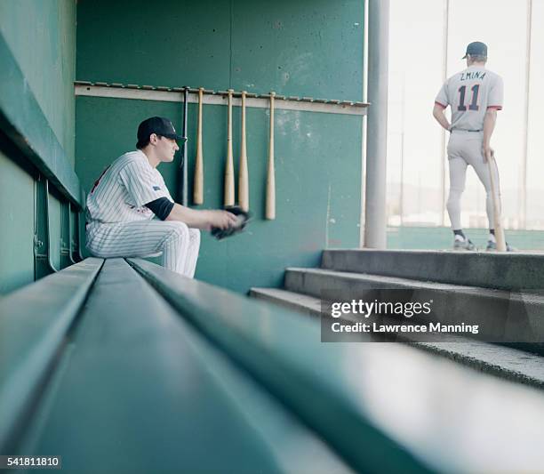 baseball player waiting on bench - dugout stock pictures, royalty-free photos & images