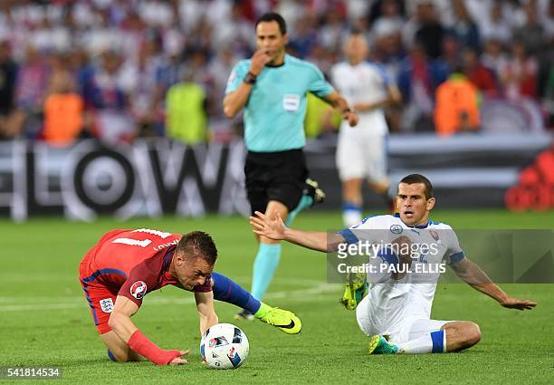 Spanish referee Carlos Velasco whistles a fouls as Slovakia's midfielder Viktor Pecovsky tackles England's forward Jamie Vardy during the Euro 2016...