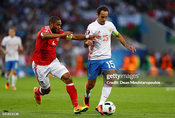 Roman Shirokov of Russia and Ashley Williams of Wales compete for the ball during the UEFA EURO 2016 Group B match between Russia and Wales at...