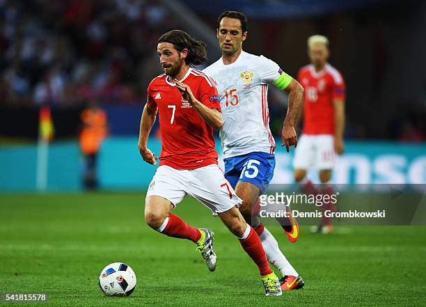 Joe Allen of Wales and Roman Shirokov of Russia compete for the ball during the UEFA EURO 2016 Group B match between Russia and Wales at Stadium...