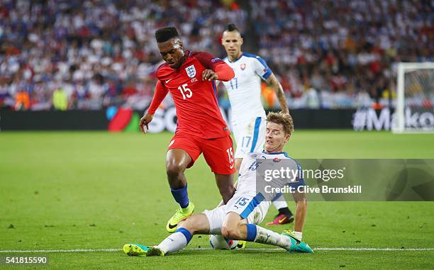 Daniel Sturridge of England is tackled by Tomas Hubocan of Slovakia during the UEFA EURO 2016 Group B match between Slovakia and England at Stade...