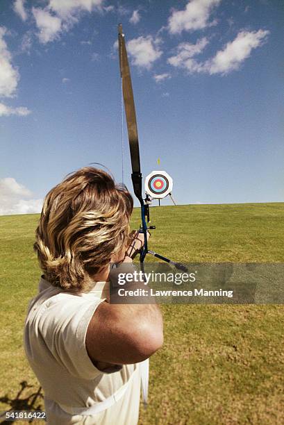 archer shooting at target - archery bow stock pictures, royalty-free photos & images