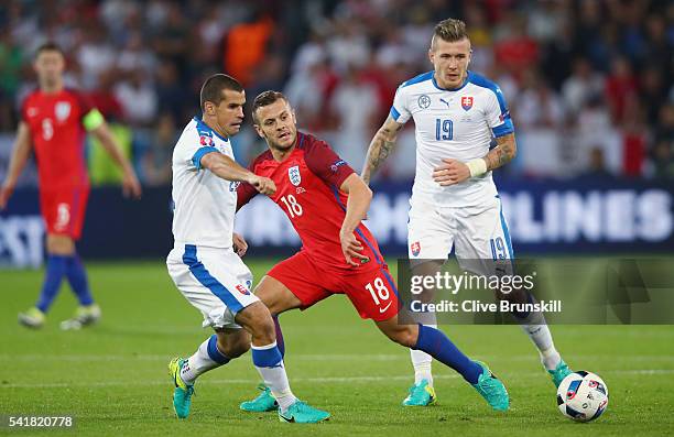 Jack Wilshire of England competes for the ball against Viktor Pecovsky and Patrik Hrosovsky of Slovakia during the UEFA EURO 2016 Group B match...