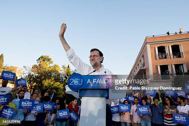 Leader of the right wing Popular Party and Spain's caretaker Prime Minister Mariano Rajoy waves his hand to his supporters during a campaign rally on...