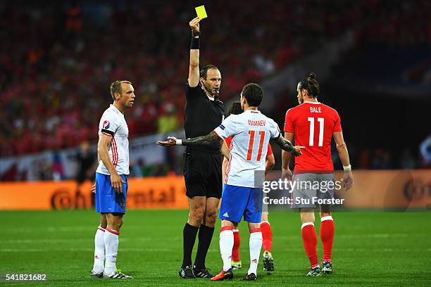 Pavel Mamaev of Russia is shown a yellow card by Referee Jonas Eriksson during the UEFA EURO 2016 Group B match between Russia and Wales at Stadium...