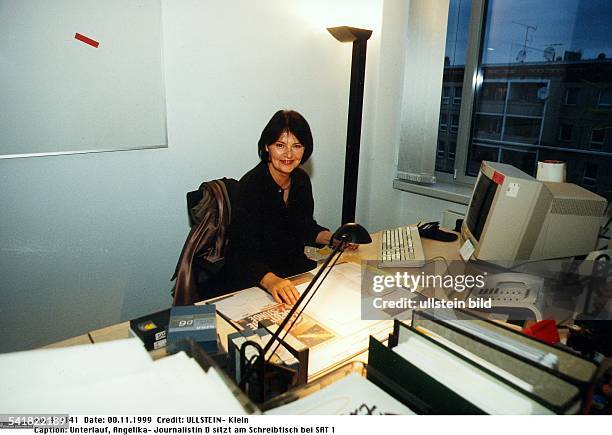 Journalistin Dsitzt am Schreibtisch bei SAT 1