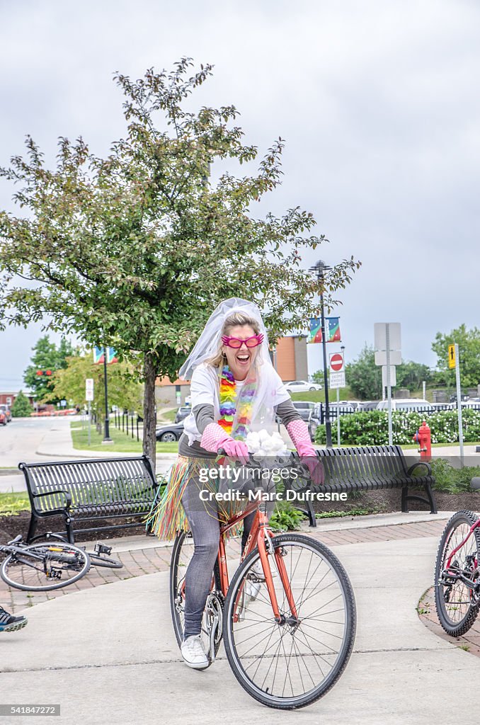 Woman having her bachelorette party costumed on a bicycle