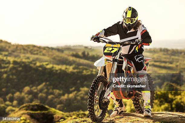 dirt bike racer on his enduro motorcycle on extreme terrain. - protective sportswear stock pictures, royalty-free photos & images