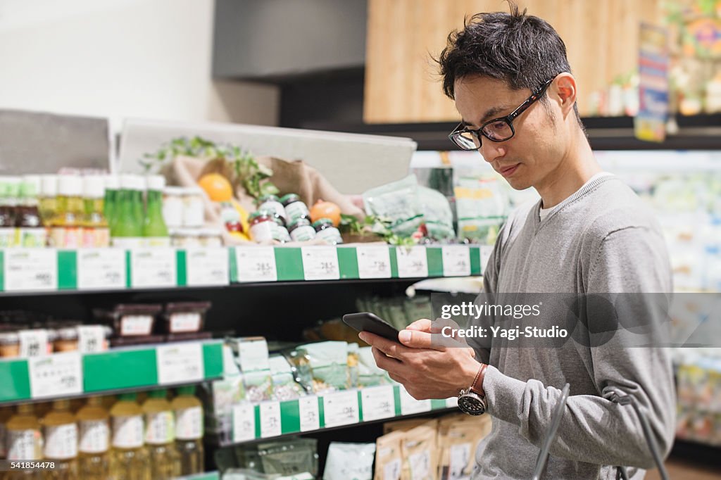 Mid adult male buying grocery in supermarket