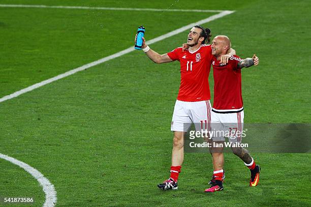 Gareth Bale and David Cotterill of Wales celebrate their team's 3-0 win in the UEFA EURO 2016 Group B match between Russia and Wales at Stadium...