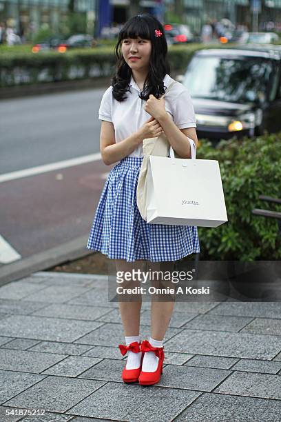 June 19: Saika Komatsu is wearing a UNIQLO shirt, an earth music & ecology blue and white plaid dress and red heels also by earth music & ecology,...