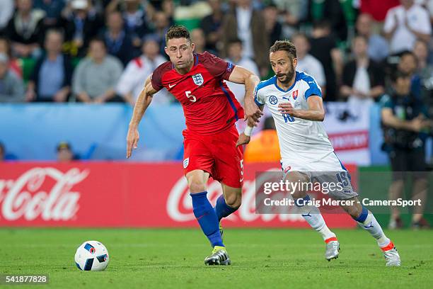 England's Gary Cahill vies for possession with Slovakia's Dusan Svento during the UEFA Euro 2016 Group B match between Slovakia and England at Stade...