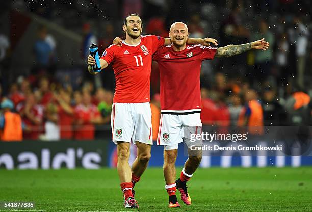 Gareth Bale and David Cotterill of Wales celebrate their team's 3-0 win in the UEFA EURO 2016 Group B match between Russia and Wales at Stadium...