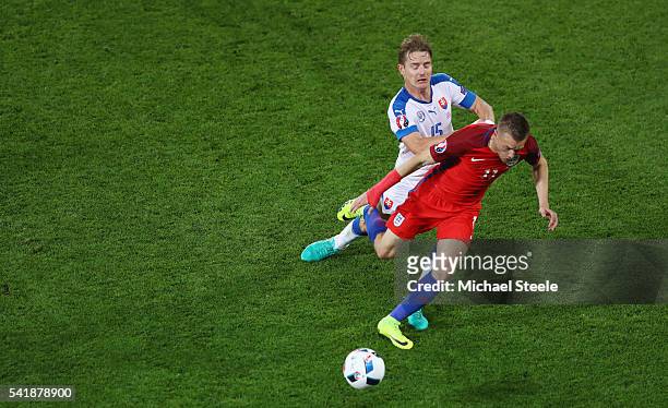 Jamie Vardy of England is challenged by Tomas Hubocan of Slovakia during the UEFA EURO 2016 Group B match between Slovakia and England at Stade...