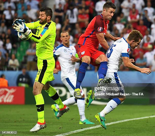 Gary Cahill of England competes for the ball against Matus Kozacik and Tomas Hubocan of Slovakia during the UEFA EURO 2016 Group B match between...