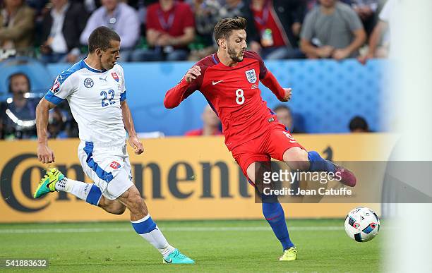 Adam Lallana of England and Viktor Pecovsky of Slovakia in action during the UEFA EURO 2016 Group B match between Slovakia and England at Stade...
