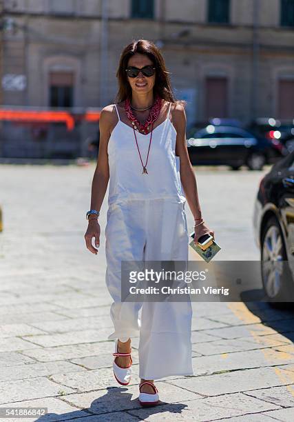 Viviana Volpicella wearing a white overall outside Gucci during the Milan Men's Fashion Week Spring/Summer 2017 on June 20, 2016 in Milan, Italy.