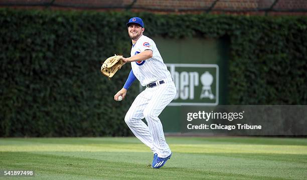 Chicago Cubs left fielder Kris Bryant throws to the plate but can't catch St. Louis Cardinals runner Kolten Wong during the second inning on Monday,...
